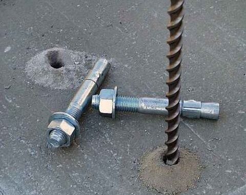 Concrete slab with a vertical rebar and two expansion anchor bolts