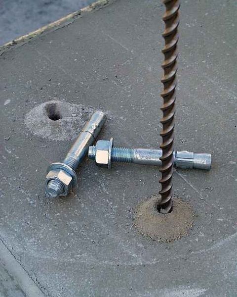 Concrete slab with a vertical rebar and two expansion anchor bolts